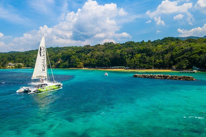 Dunn's River Catamaran Cruise From Ocho Rios - Onboard vibe you can feel right away: DJ, safety briefing, snacks, and open bar